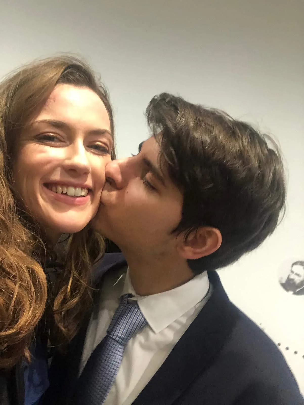 Couple selfie with a kiss on the cheek
