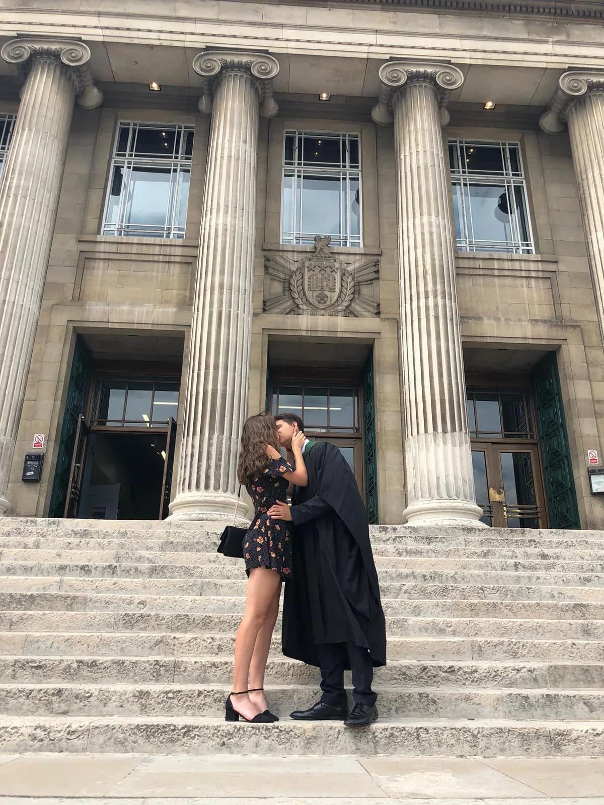 Mateo in graduation gown with Kirsty holding certificate